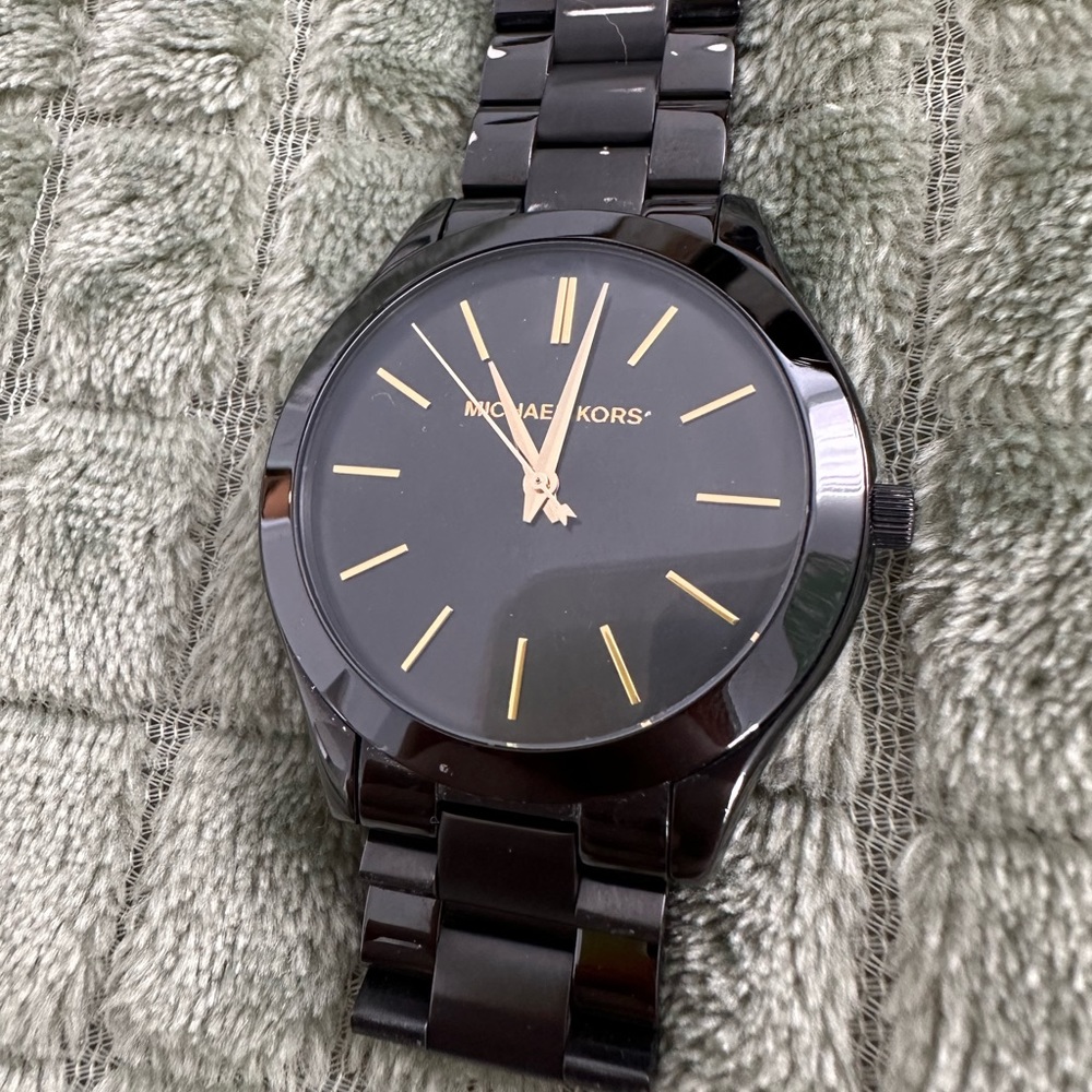 Michael Kors black and gold watch.